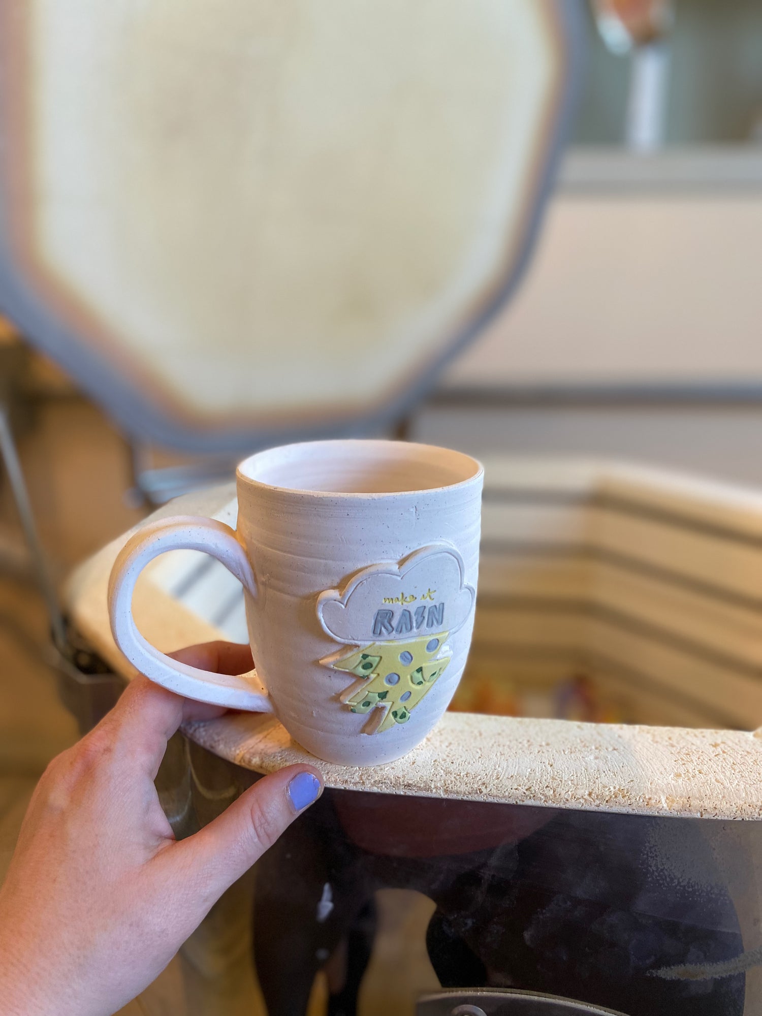 make it rain mug on the edge of the kiln