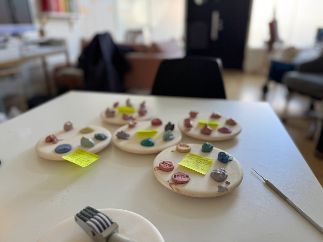 test tiles of colored clay in progress