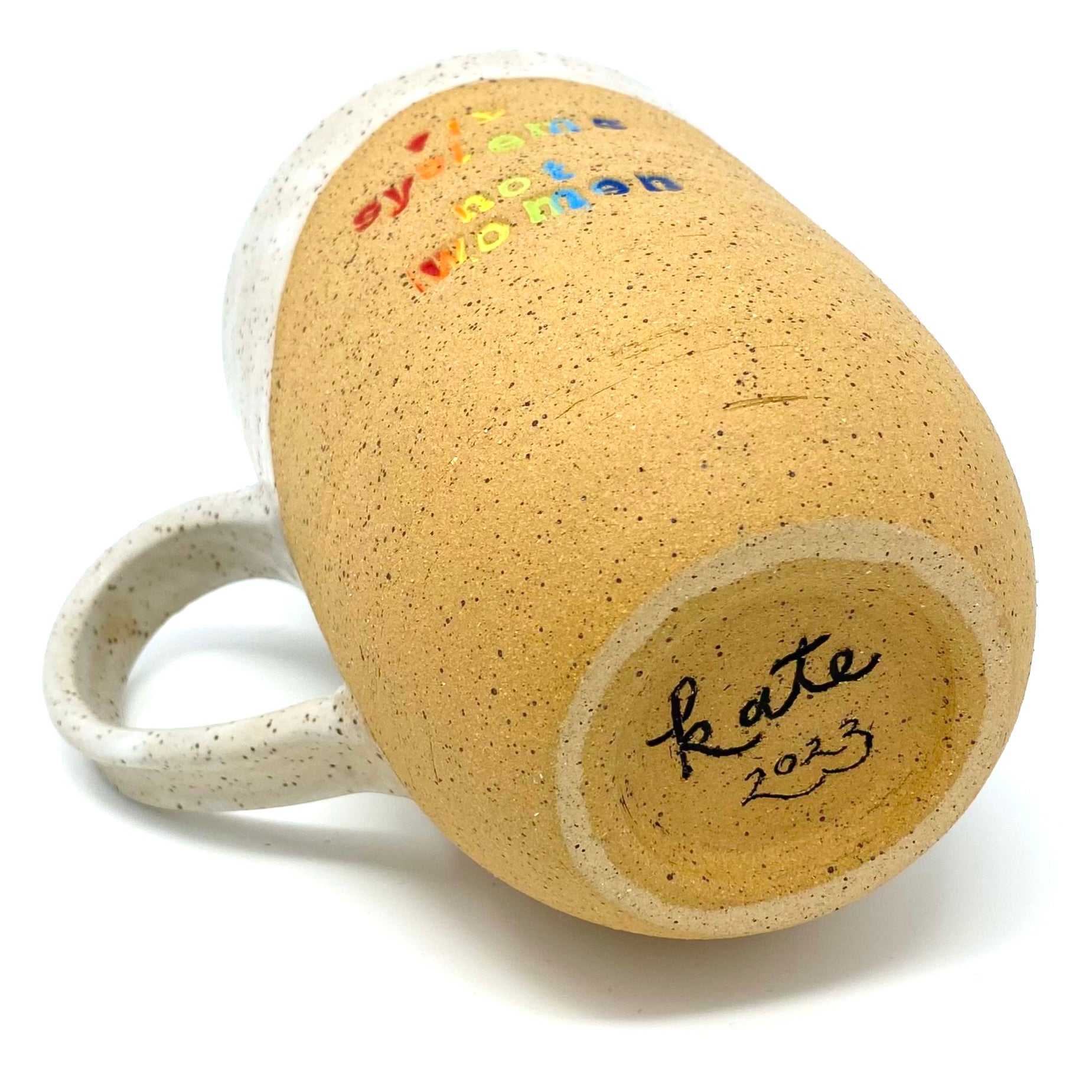 mug as seen from the bottom, with a sanded foot ring, and signed "kate 2023" in black.